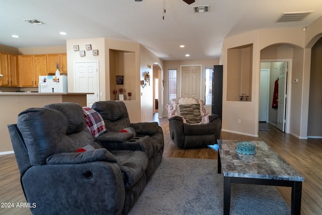 living room with ceiling fan and light wood-type flooring