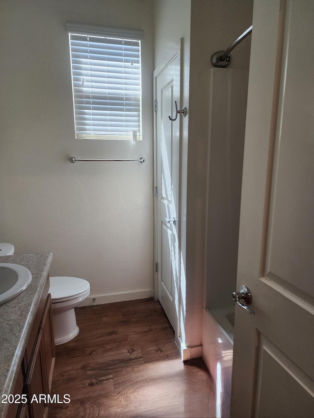 7251 E Grouse Ct, San Tan Valley, AZ 85143 - bathroom with tub / shower combination, baseboards, toilet, wood finished floors, and vanity