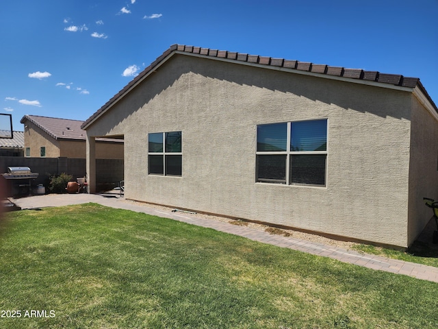 7251 E Grouse Ct, San Tan Valley, AZ 85143 - rear view of property featuring fence, a yard, a patio area, and stucco siding