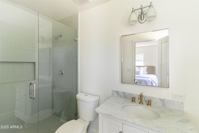 ensuite bathroom with a shower stall, toilet, and vanity