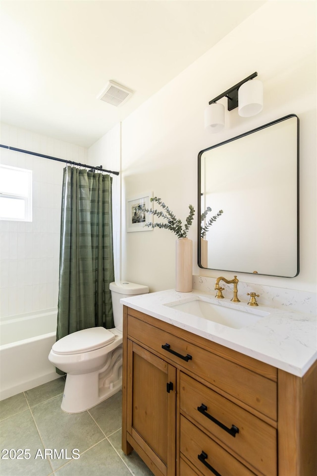 bathroom with toilet, tile patterned floors, vanity, and shower / bath combo with shower curtain
