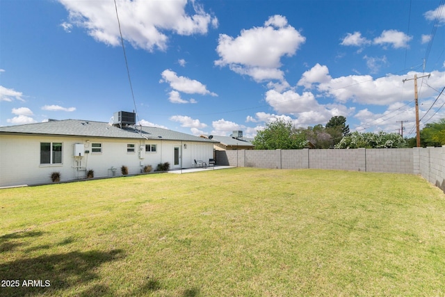 view of yard with cooling unit and a patio