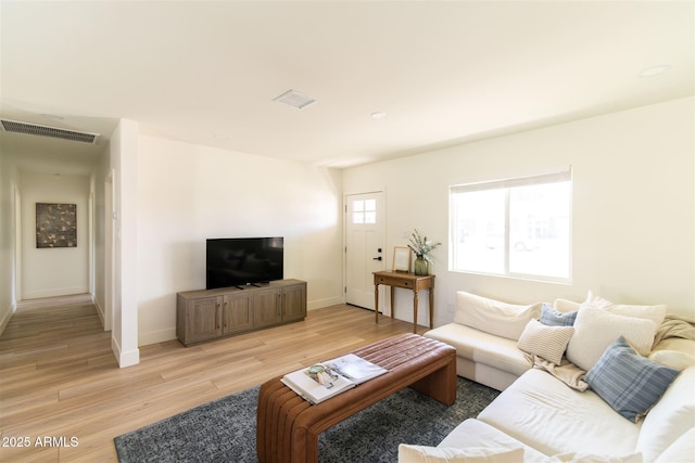 living area with light wood-style floors and baseboards