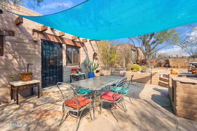 view of patio featuring outdoor dining space and fence