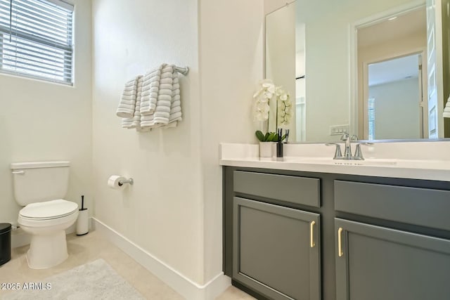 bathroom featuring vanity, toilet, and tile patterned flooring