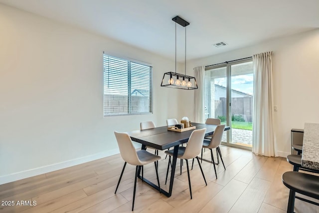 dining space with light hardwood / wood-style flooring