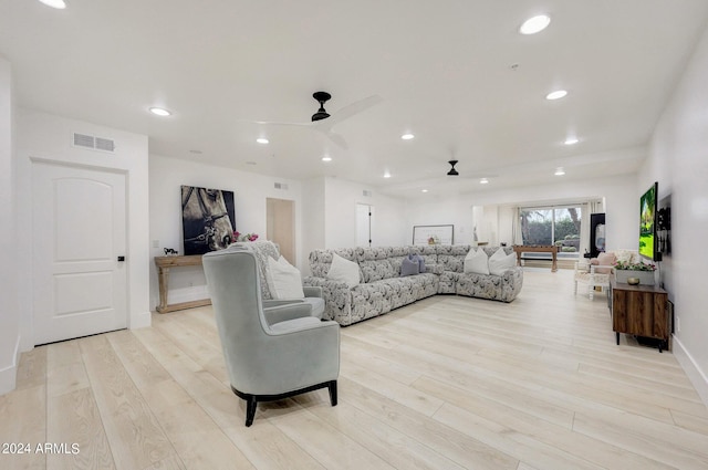 living room featuring ceiling fan and light wood-type flooring