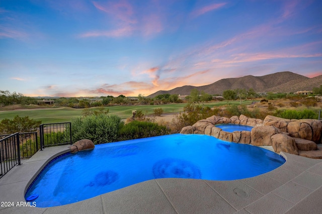 pool at dusk with a mountain view