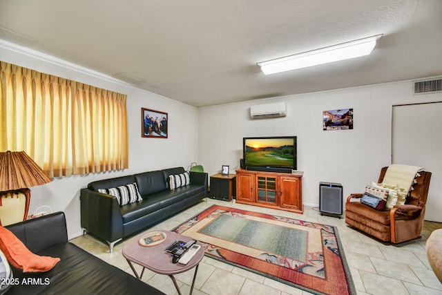 living area featuring visible vents, a wall unit AC, and tile patterned floors