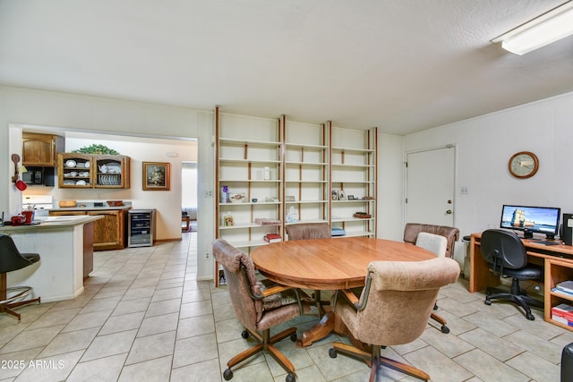dining room featuring beverage cooler and light tile patterned floors