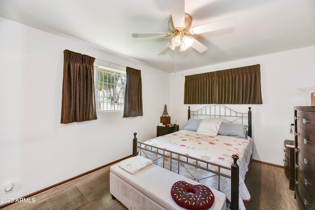 bedroom with a ceiling fan, carpet floors, and baseboards