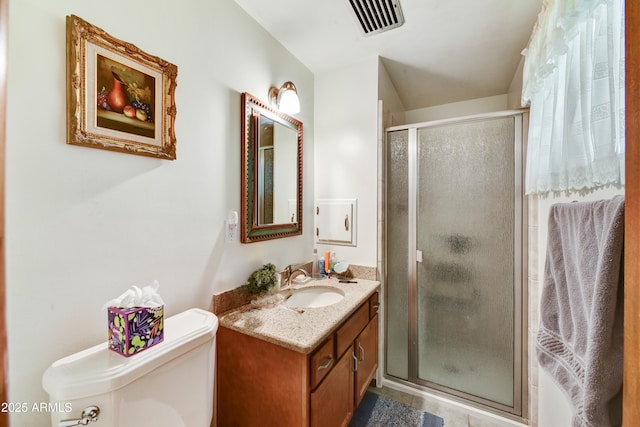 bathroom with vanity, toilet, a stall shower, visible vents, and tile patterned flooring