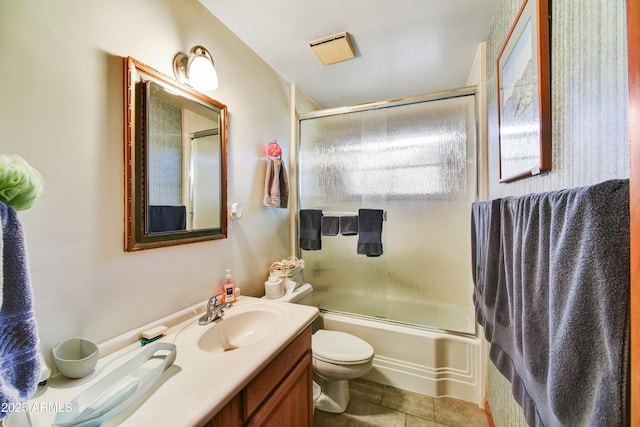 full bathroom with tile patterned floors, vanity, toilet, and shower / bath combination with glass door
