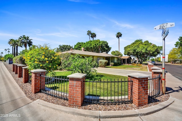 ranch-style home with fence, a front lawn, and concrete driveway