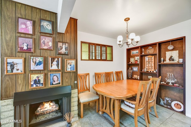 dining area with light tile patterned floors and a notable chandelier