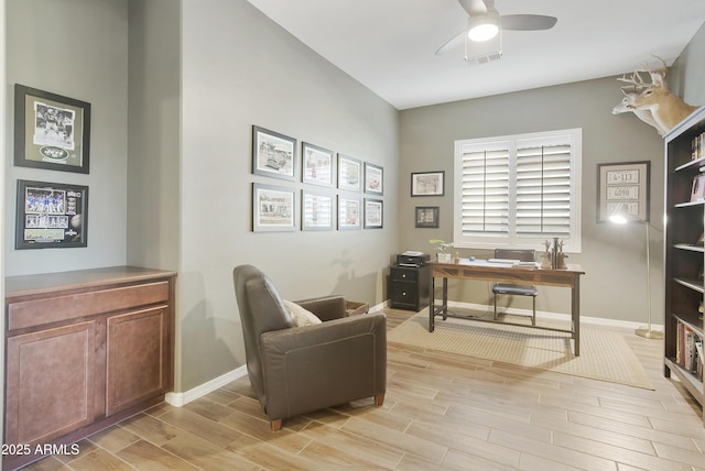 office with baseboards, a ceiling fan, and wood finish floors