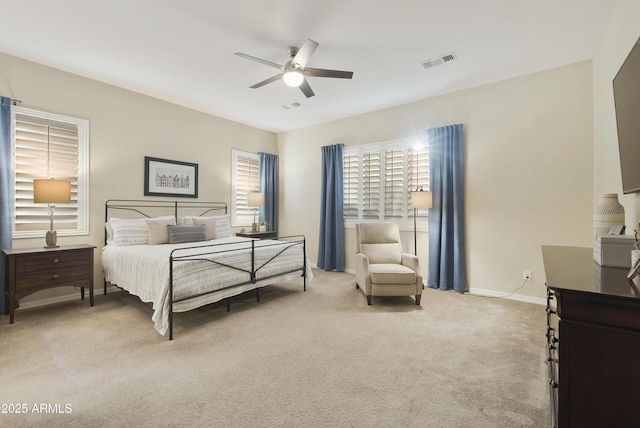 bedroom with a ceiling fan, carpet flooring, visible vents, and baseboards