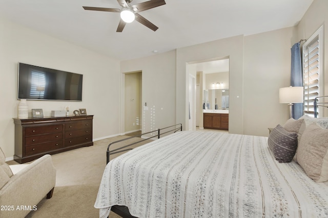 bedroom with carpet, ceiling fan, baseboards, and ensuite bathroom