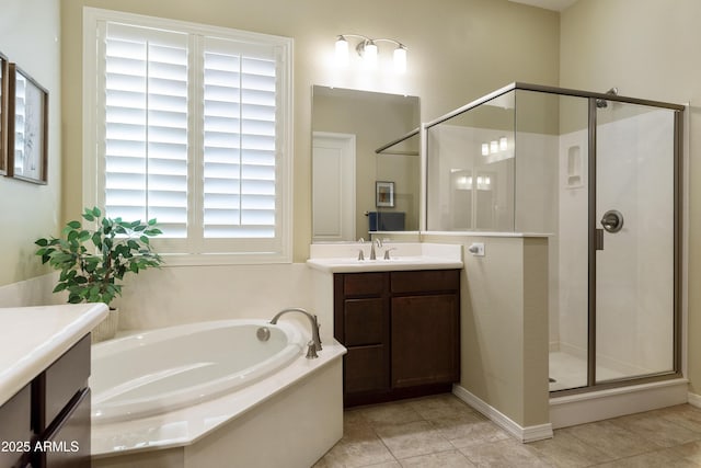 full bathroom with a stall shower, tile patterned flooring, vanity, and a bath