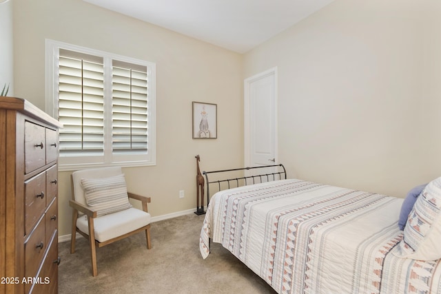 carpeted bedroom featuring baseboards