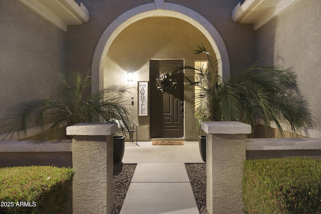 property entrance with stucco siding