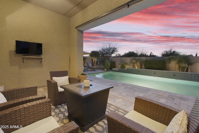 pool with a patio area, a fenced backyard, and an outdoor living space