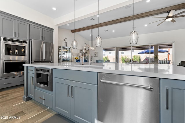 17385 W Sugar Hill Ct, Surprise, AZ 85388 - kitchen featuring stainless steel appliances, a sink, light countertops, beam ceiling, and recessed lighting