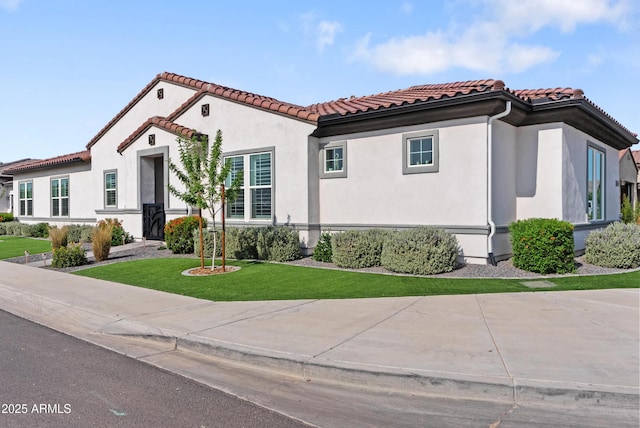 17385 W Sugar Hill Ct, Surprise, AZ 85388 - mediterranean / spanish-style house with a tile roof, a front lawn, and stucco siding