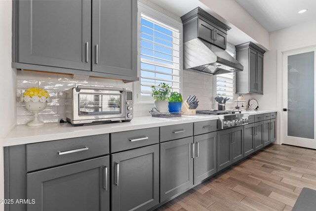 17385 W Sugar Hill Ct, Surprise, AZ 85388 - kitchen with stainless steel gas stovetop, gray cabinetry, decorative backsplash, light countertops, and recessed lighting