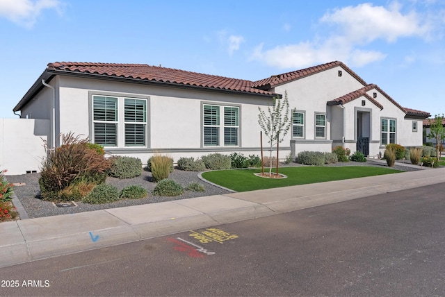 17385 W Sugar Hill Ct, Surprise, AZ 85388 - mediterranean / spanish-style home with stucco siding, a front yard, and a tile roof