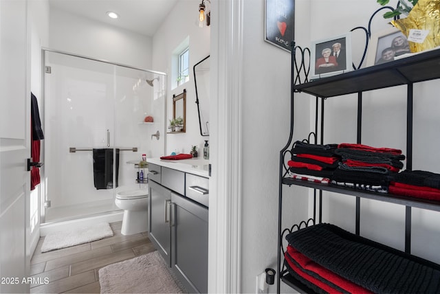 17385 W Sugar Hill Ct, Surprise, AZ 85388 - bathroom featuring toilet, vanity, a shower stall, wood finished floors, and recessed lighting