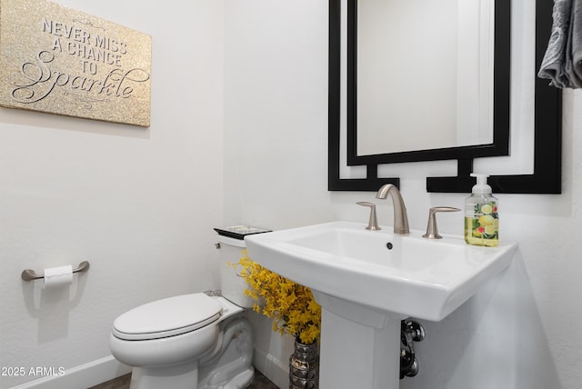 17385 W Sugar Hill Ct, Surprise, AZ 85388 - bathroom featuring toilet, a sink, and baseboards