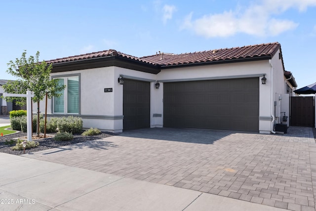 17385 W Sugar Hill Ct, Surprise, AZ 85388 - mediterranean / spanish home with a garage, decorative driveway, stucco siding, and a tile roof