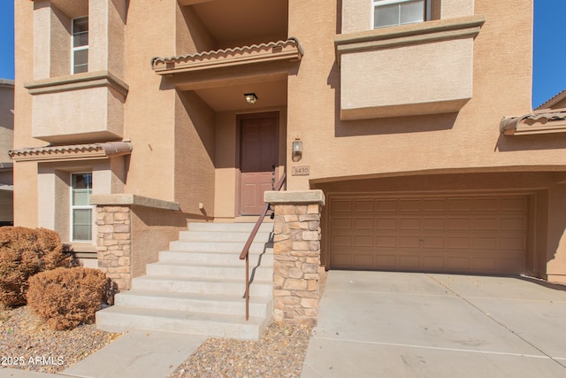 doorway to property with a garage