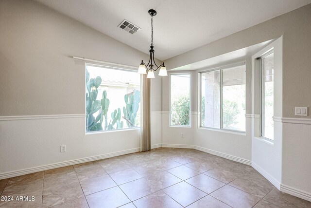 unfurnished dining area with lofted ceiling, plenty of natural light, light tile patterned floors, and a chandelier