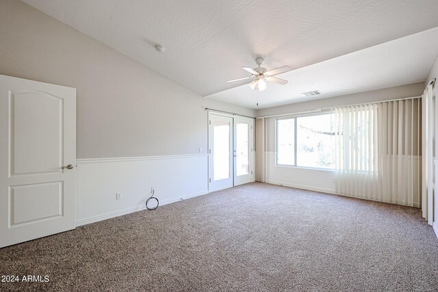 carpeted spare room featuring a textured ceiling and ceiling fan