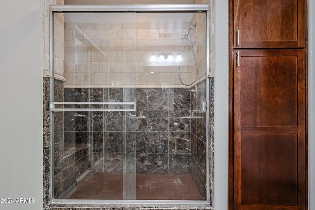 bathroom with a shower with door