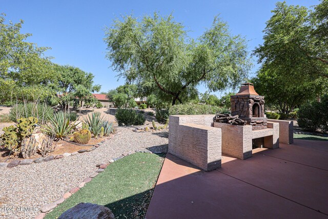 view of patio / terrace featuring an outdoor fireplace