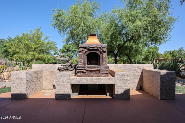 view of patio / terrace featuring an outdoor stone fireplace