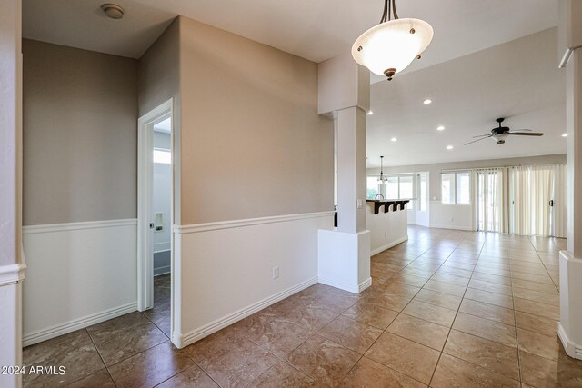 interior space with ceiling fan