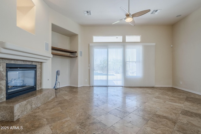 unfurnished living room with a ceiling fan, baseboards, and visible vents