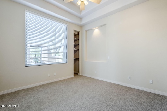 spare room featuring baseboards, carpet, and a ceiling fan