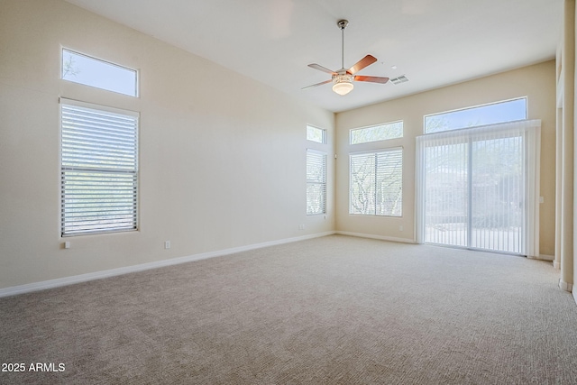 unfurnished room with carpet floors, ceiling fan, baseboards, and visible vents
