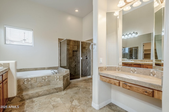 bathroom with vanity, a bath, and a stall shower