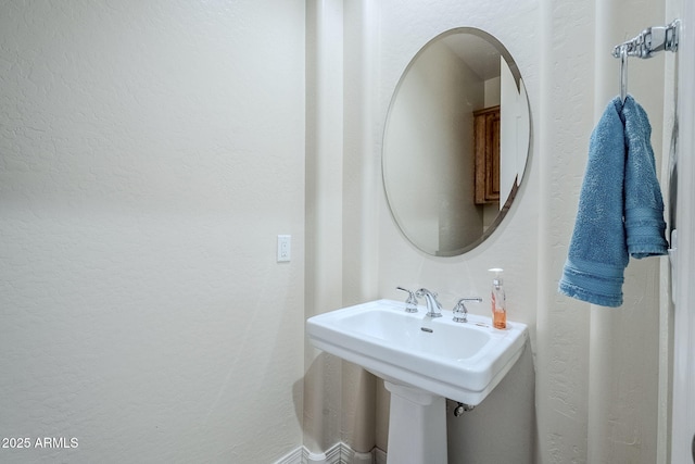 bathroom featuring a textured wall