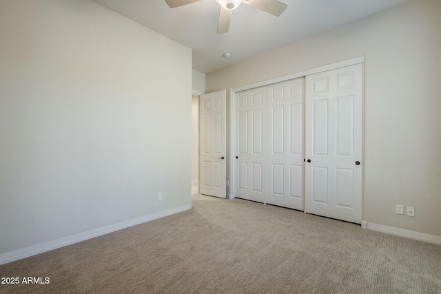 unfurnished bedroom featuring a ceiling fan, baseboards, carpet, and a closet