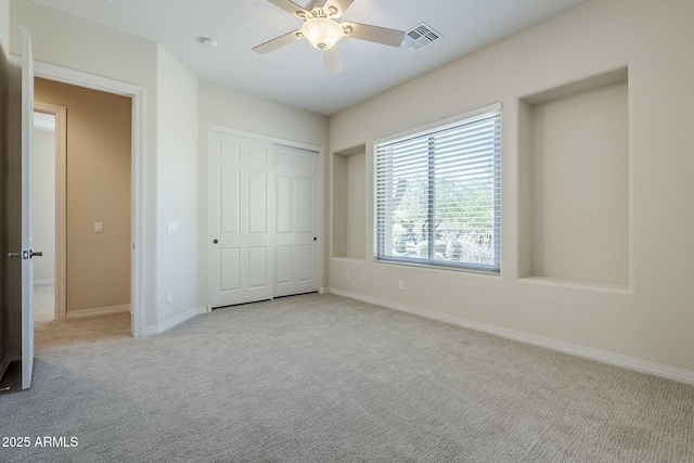 unfurnished bedroom with visible vents, carpet, and baseboards