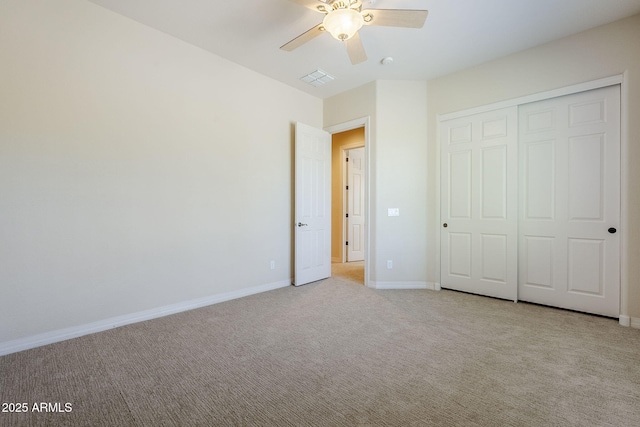 unfurnished bedroom with ceiling fan, light colored carpet, baseboards, visible vents, and a closet