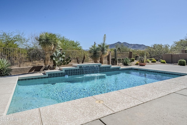 view of pool with a fenced backyard, a fenced in pool, and a mountain view
