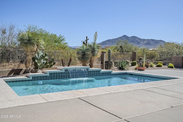 view of swimming pool with fence, a mountain view, and a fenced in pool